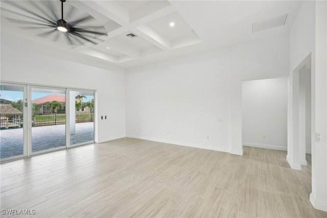 unfurnished room featuring beam ceiling, ceiling fan, coffered ceiling, and light wood-type flooring