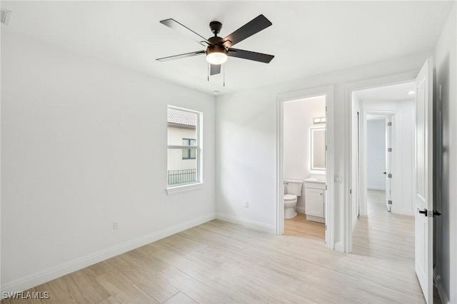 unfurnished bedroom featuring light wood-type flooring, connected bathroom, and ceiling fan