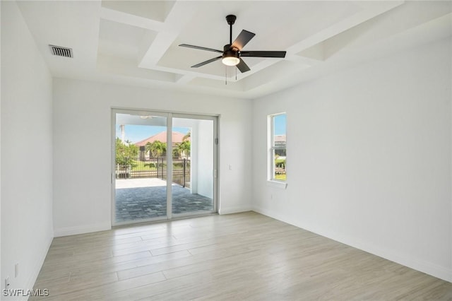 empty room featuring ceiling fan, light wood-type flooring, and coffered ceiling