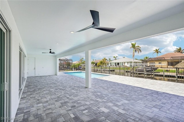 view of swimming pool with ceiling fan, a water view, and a patio