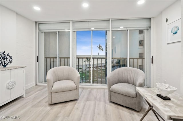 sitting room featuring light hardwood / wood-style flooring and expansive windows