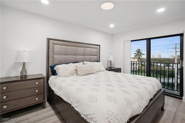 bedroom with access to exterior and light wood-type flooring