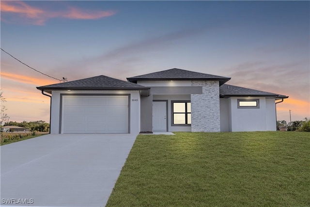 prairie-style house with a lawn and a garage