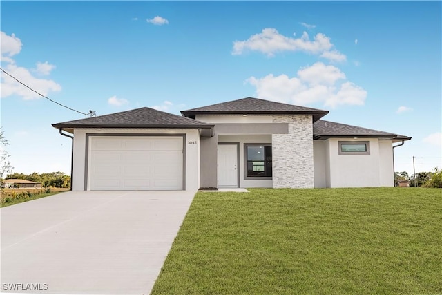 prairie-style house featuring a front yard and a garage