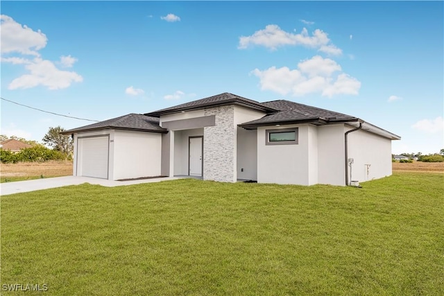 view of front of home featuring a garage and a front lawn