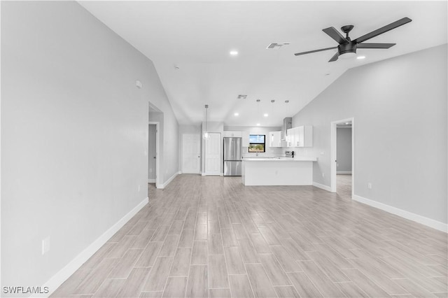 unfurnished living room with ceiling fan and lofted ceiling