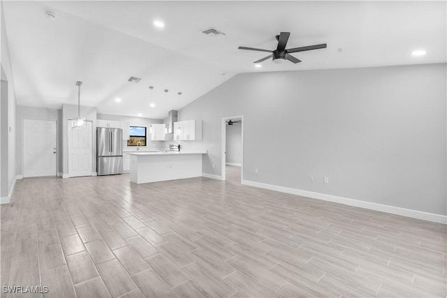 unfurnished living room with ceiling fan and lofted ceiling