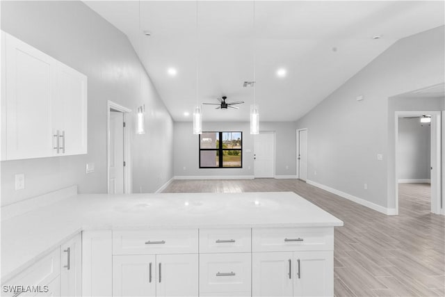 kitchen with white cabinetry, ceiling fan, and lofted ceiling