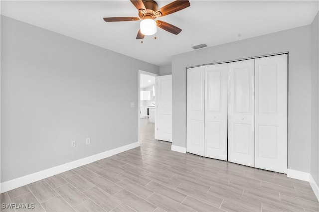 unfurnished bedroom with a closet and ceiling fan