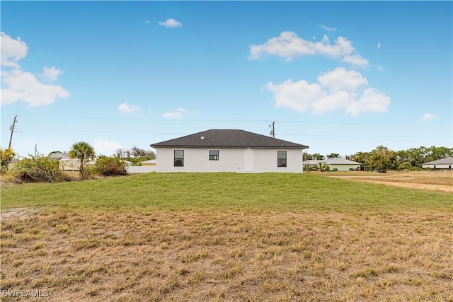 rear view of house with a lawn