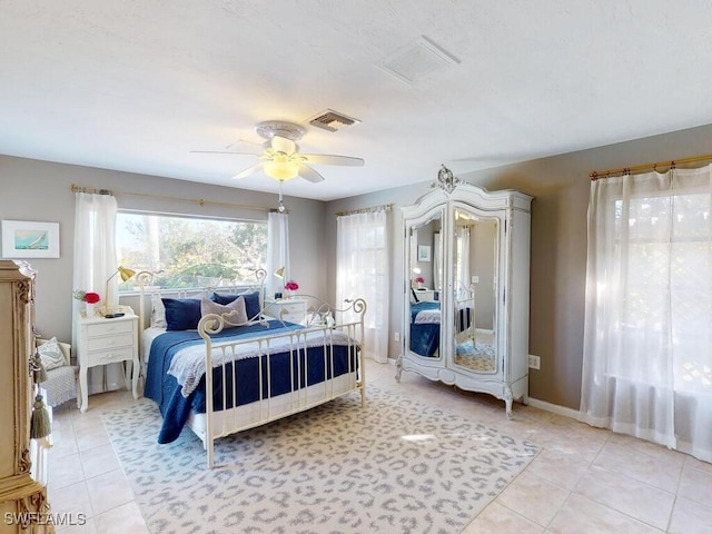 tiled bedroom featuring ceiling fan