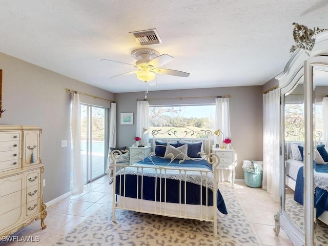 tiled bedroom with access to outside and ceiling fan