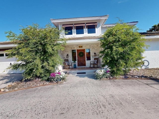 view of front of home featuring a garage and covered porch