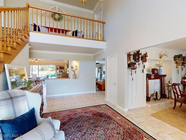 entryway featuring a high ceiling, ornamental molding, and light tile patterned floors