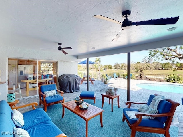 interior space featuring ceiling fan, area for grilling, an outdoor hangout area, and a fenced in pool