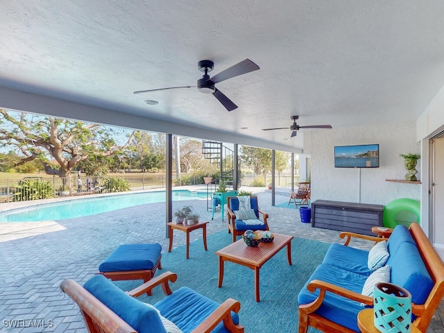 view of patio featuring an outdoor living space, a fenced in pool, and ceiling fan