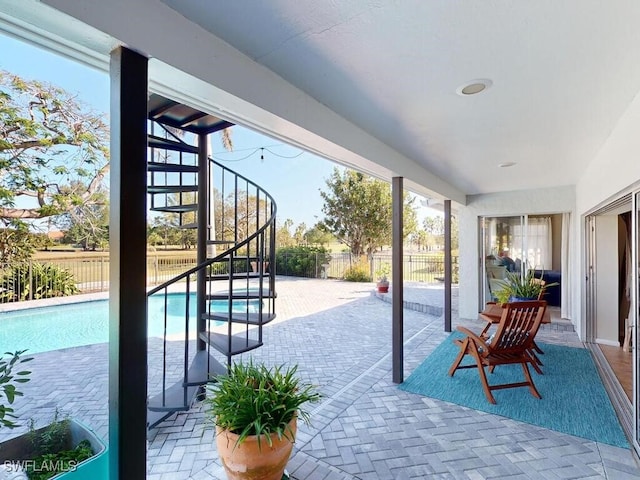 view of patio featuring a fenced in pool