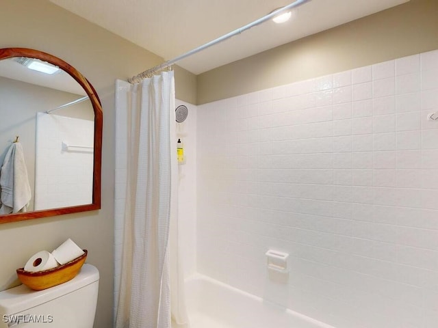 bathroom with shower / tub combo and toilet