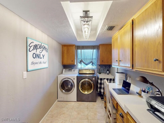 laundry room featuring light tile patterned flooring, separate washer and dryer, and a notable chandelier