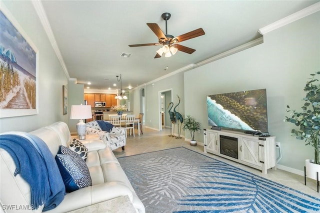 tiled living room with ceiling fan with notable chandelier and crown molding