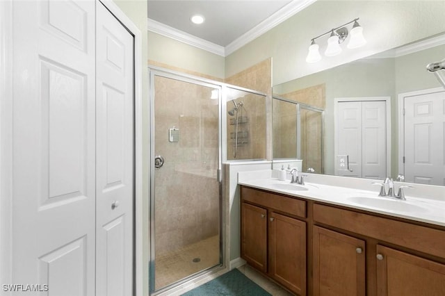 bathroom with vanity, a shower with door, and ornamental molding