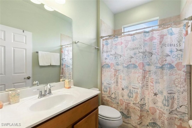 bathroom with vanity, a shower with shower curtain, and toilet