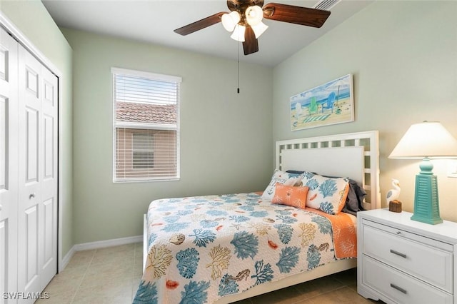 bedroom with ceiling fan, a closet, and light tile patterned flooring