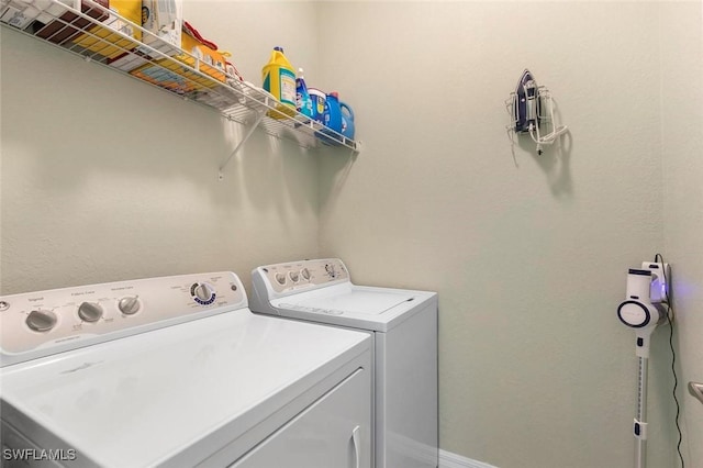 clothes washing area with separate washer and dryer