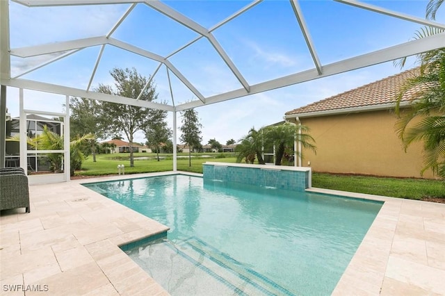 view of pool with pool water feature, a patio area, a lanai, and a yard