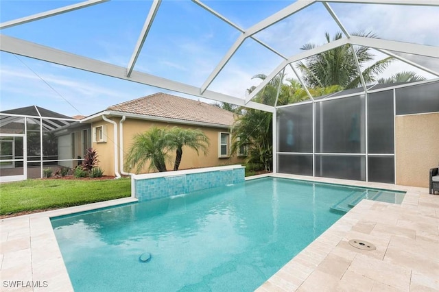 view of swimming pool with a lanai and a patio area