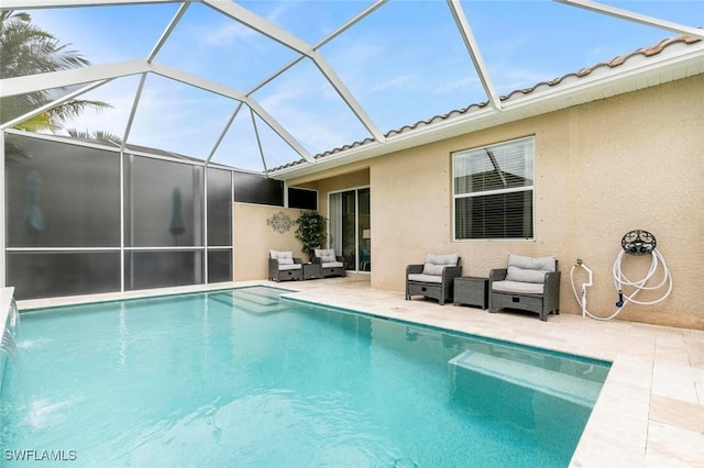 view of swimming pool featuring pool water feature, a lanai, and a patio