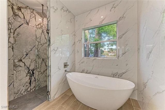 bathroom featuring independent shower and bath