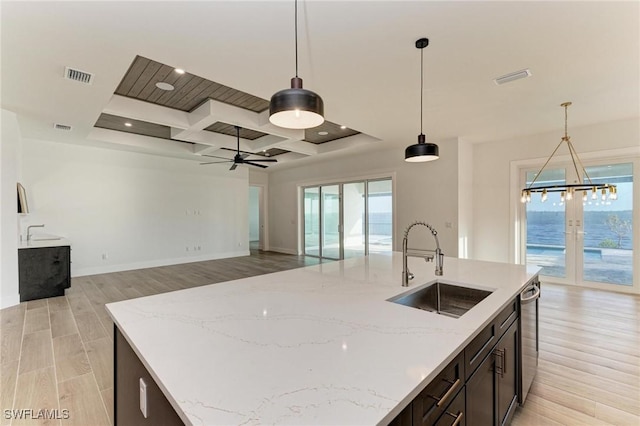 kitchen with decorative light fixtures, ceiling fan, and sink