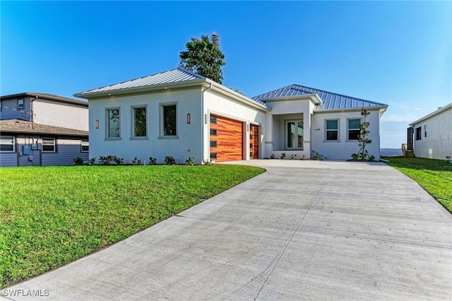 view of front of house featuring a front lawn and a garage