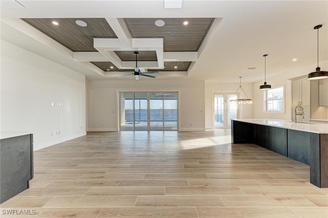 unfurnished living room with ceiling fan and wood ceiling