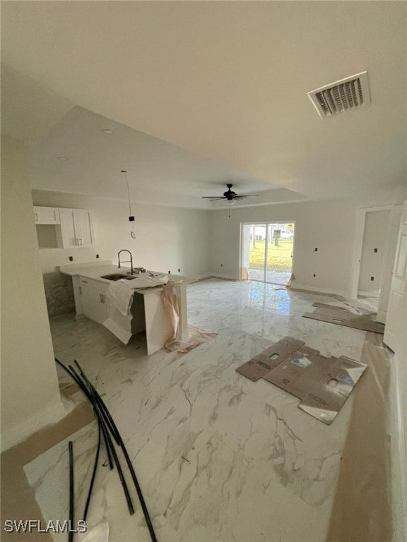 interior space featuring ceiling fan and sink