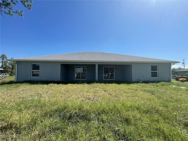 1108/1110 Circle Dr, Lehigh Acres, FL 33973 - back of property featuring stucco siding