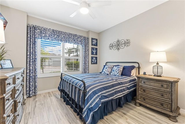 bedroom with ceiling fan and light hardwood / wood-style floors