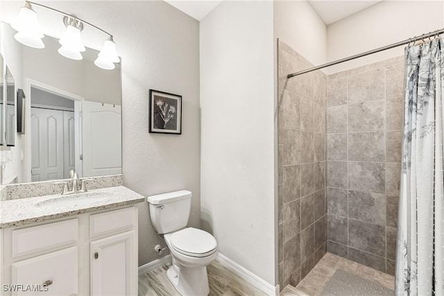 bathroom with toilet, vanity, and a shower with curtain