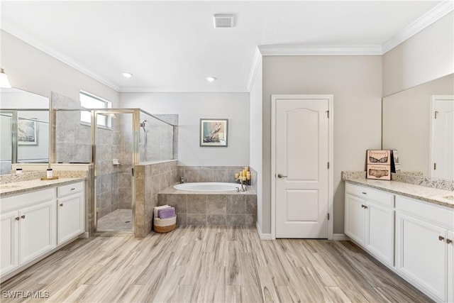 bathroom with wood-type flooring, vanity, ornamental molding, and plus walk in shower