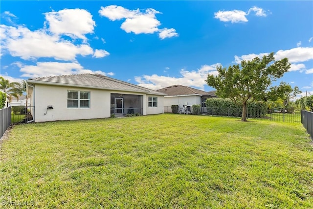 rear view of house with a lawn