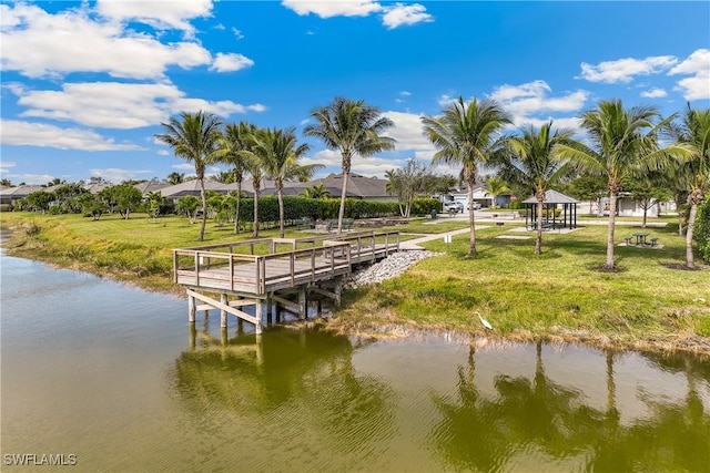 view of dock with a water view, a gazebo, and a yard