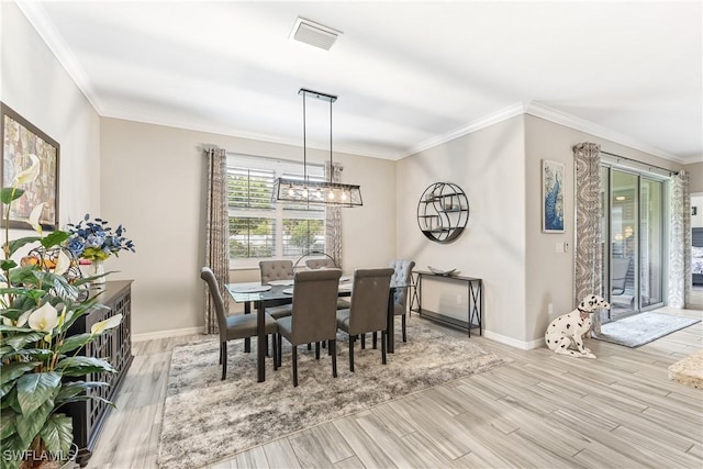 dining area featuring light wood-type flooring and ornamental molding