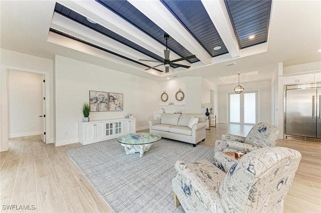 living room featuring beam ceiling, light hardwood / wood-style flooring, french doors, and ceiling fan