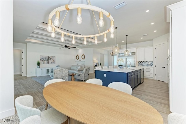 dining room with ceiling fan and sink