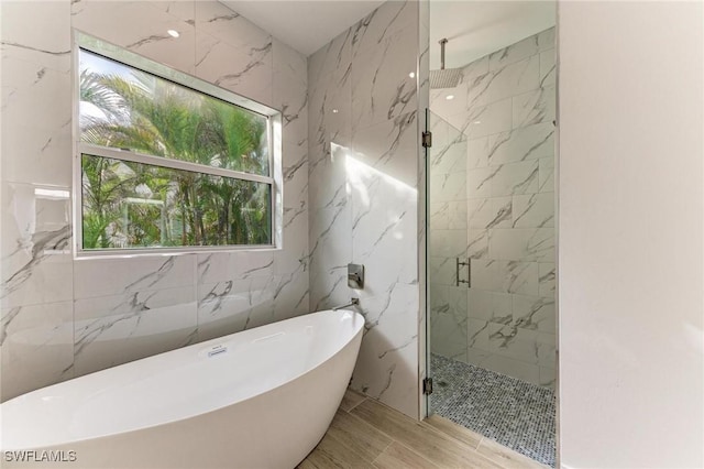 bathroom featuring separate shower and tub