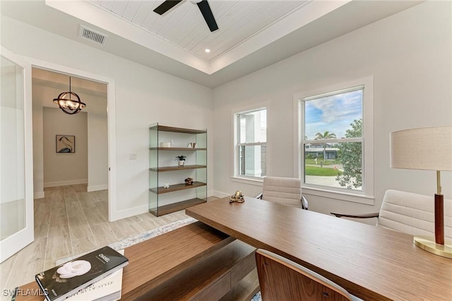 unfurnished office with ceiling fan, a raised ceiling, wood ceiling, and light hardwood / wood-style flooring