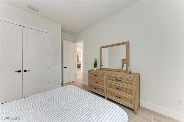 bedroom featuring a closet and light hardwood / wood-style floors