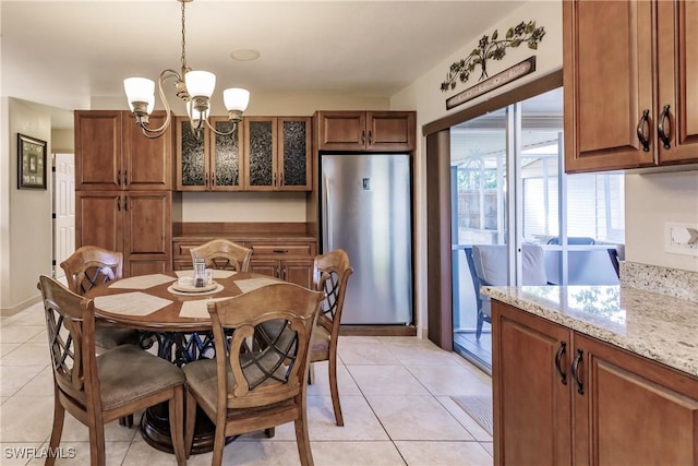 tiled dining room with an inviting chandelier