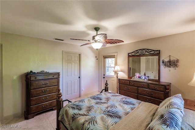 tiled bedroom with ceiling fan